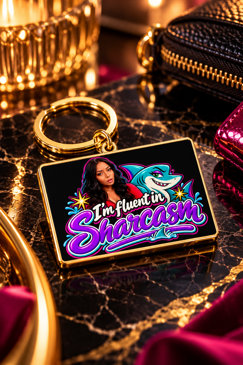 Gold plated Sharkasm keychain featured on luxury black marble